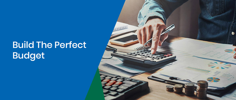 Build The Perfect Budget - close up of a person with a calculator and spreadsheets